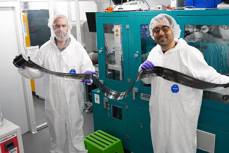 Researchers Dave Beynon and Ershad Paravazian with a roll of printed perovskite PV